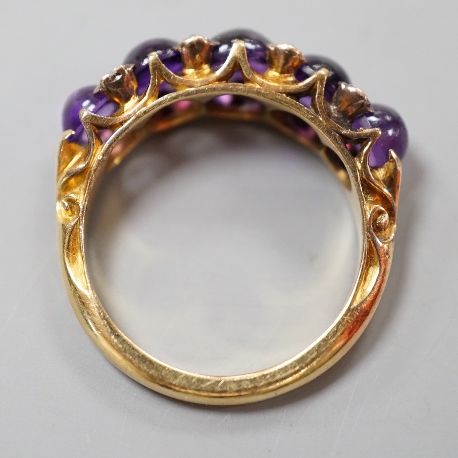 A late Victorian yellow metal and five stone graduated cabochon amethyst set half hoop ring, with rose cut diamond chip spacers, size M, gross weight 4.7 grams.